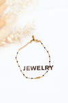 Fashionable anklet with a feather gold